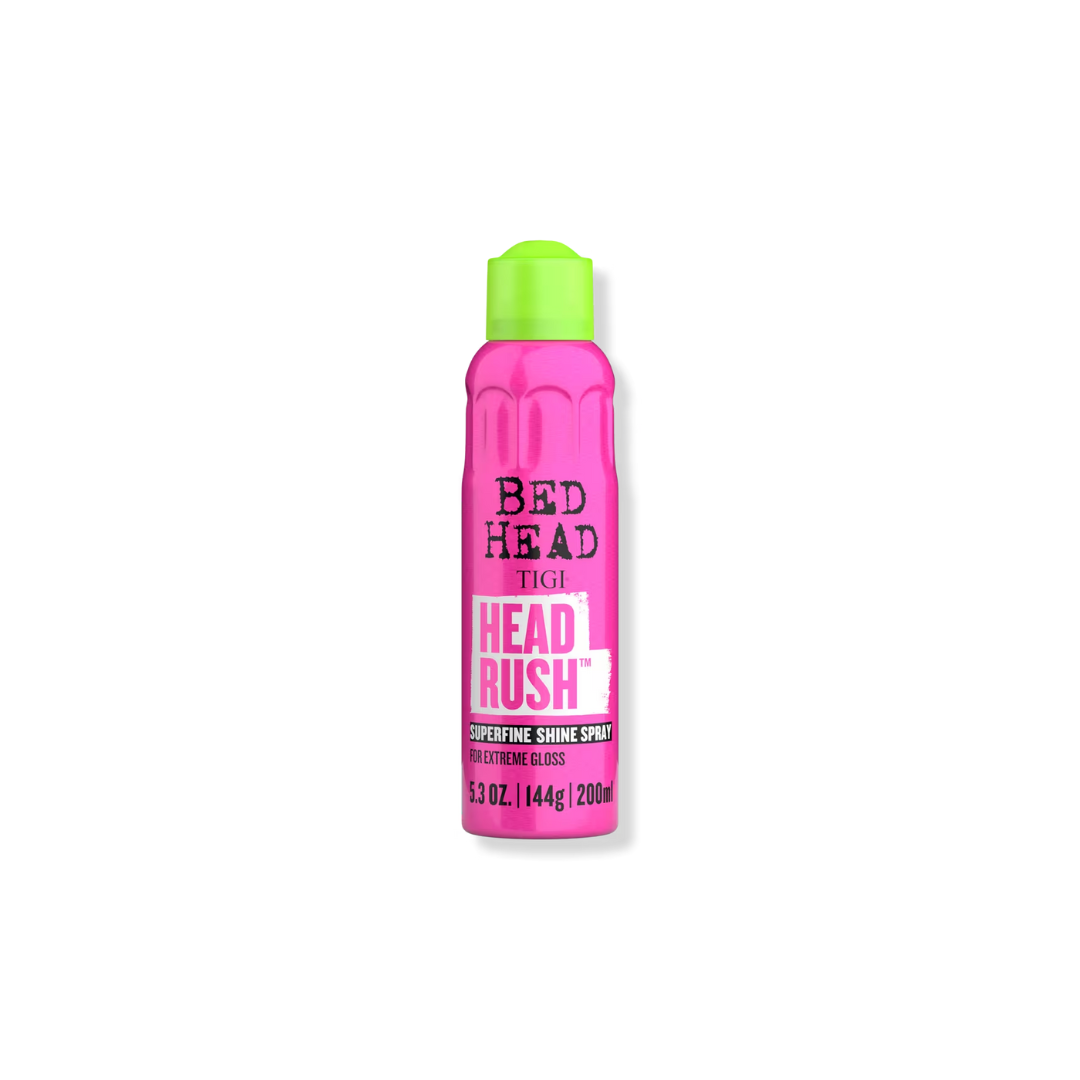 A single bottle of Tigi Bed Head Tigi Head Rush Superfine Shine Spray in a vibrant pink color with a bright lime green cap, centered on a plain white background.